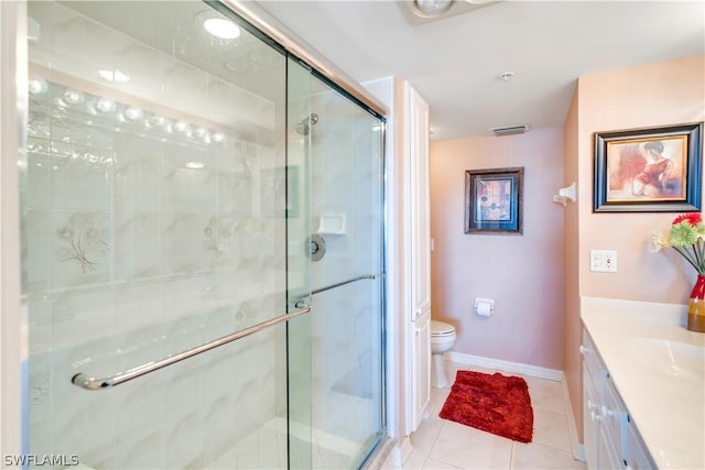 bathroom with toilet, vanity, tile patterned floors, and walk in shower