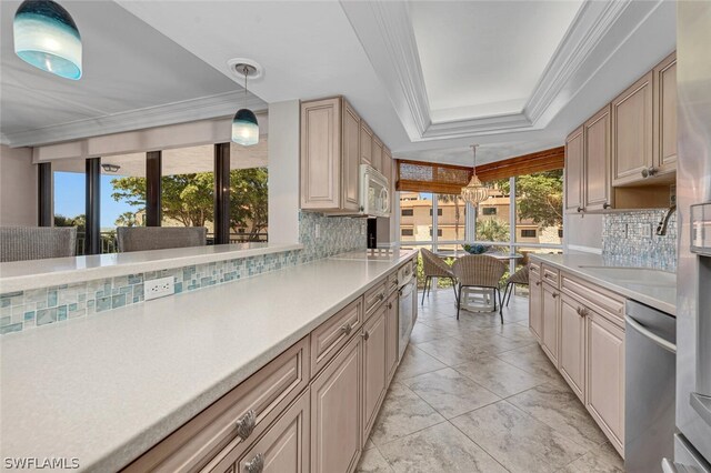 kitchen featuring decorative light fixtures, stainless steel dishwasher, decorative backsplash, and light brown cabinets