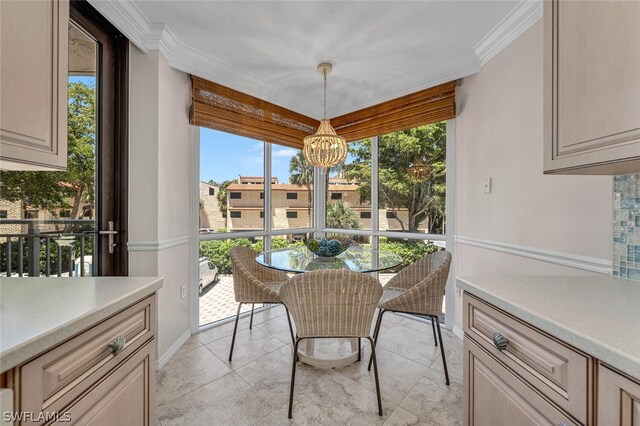 sunroom / solarium with a healthy amount of sunlight and an inviting chandelier