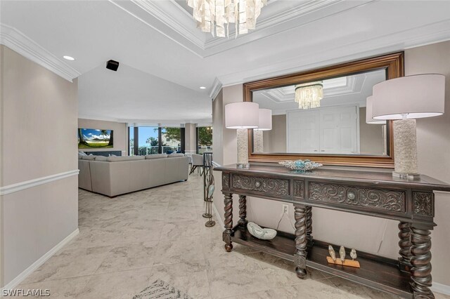 hall with an inviting chandelier and crown molding