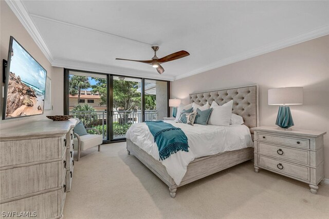 carpeted bedroom with access to outside, ornamental molding, ceiling fan, and expansive windows