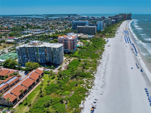 drone / aerial view featuring a beach view and a water view