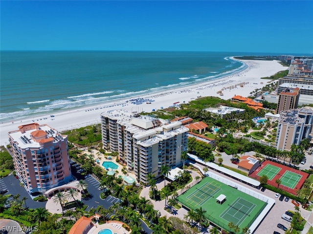 birds eye view of property featuring a beach view and a water view