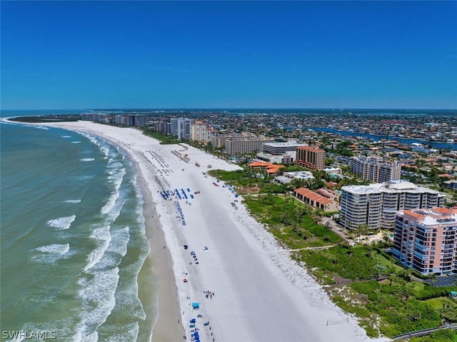 birds eye view of property with a beach view and a water view