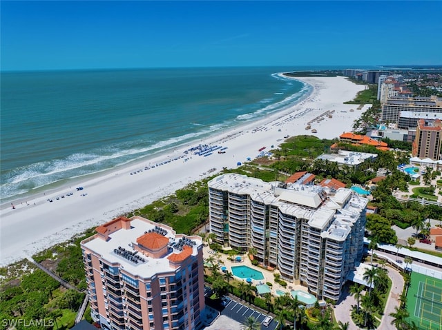 drone / aerial view featuring a water view and a view of the beach