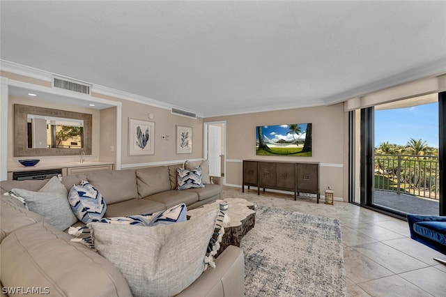 tiled living room featuring ornamental molding and plenty of natural light