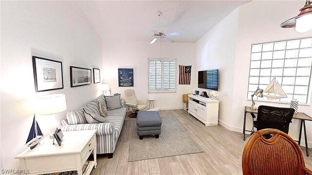 living room with ceiling fan and light hardwood / wood-style floors