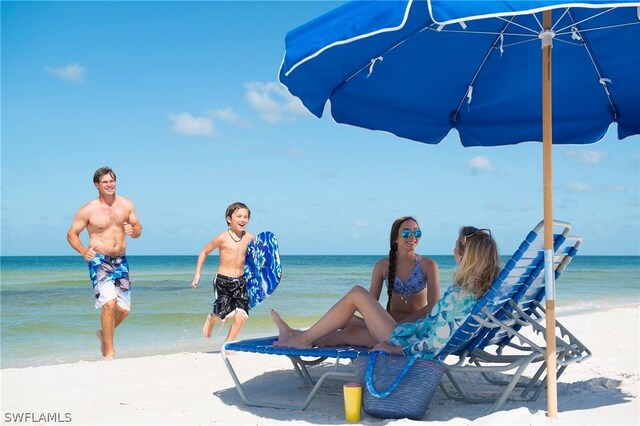 view of property's community featuring a view of the beach and a water view