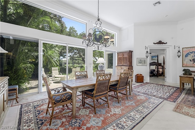 dining area with a notable chandelier, crown molding, light tile flooring, and a high ceiling