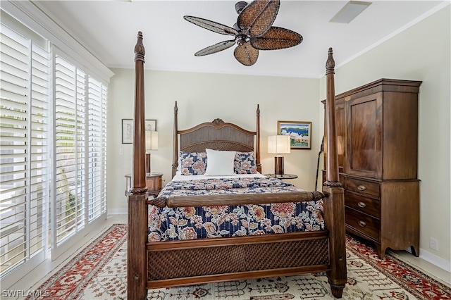 bedroom featuring ceiling fan and crown molding