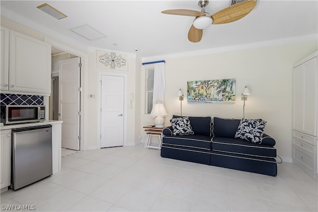 living room featuring ceiling fan, crown molding, and light tile floors