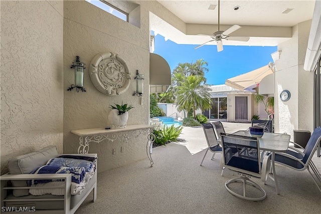 view of terrace with a pool and ceiling fan