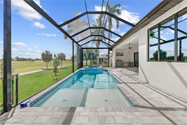 view of pool with ceiling fan, a yard, glass enclosure, and a patio