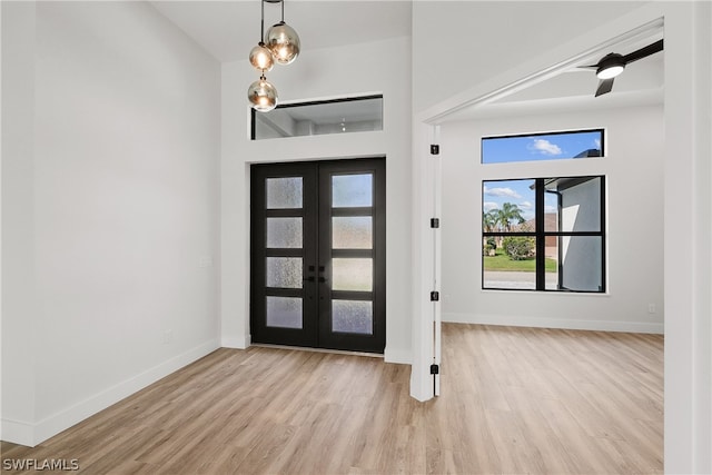 entrance foyer featuring french doors and light hardwood / wood-style floors