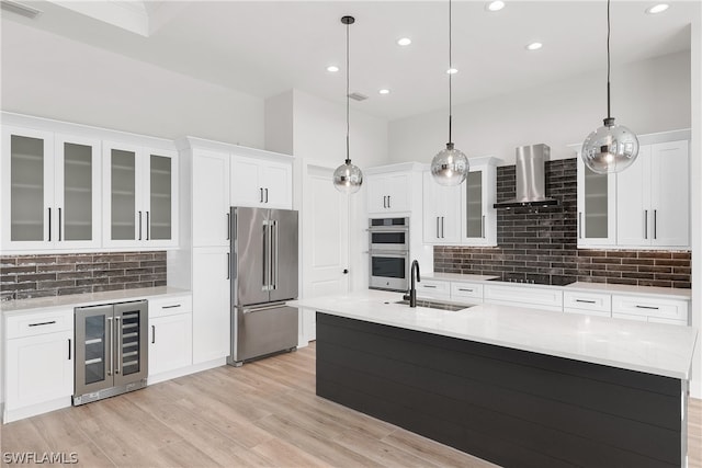 kitchen with appliances with stainless steel finishes, backsplash, wine cooler, wall chimney range hood, and sink