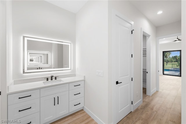 bathroom featuring ceiling fan, vanity, and hardwood / wood-style flooring