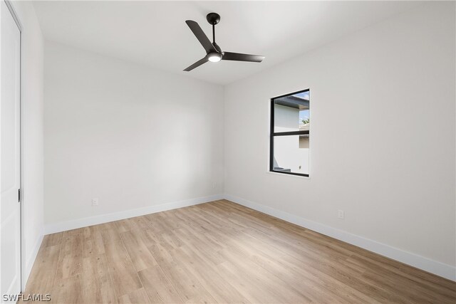 spare room with ceiling fan and light wood-type flooring