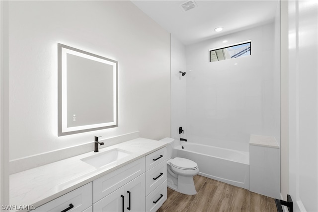 full bathroom featuring wood-type flooring,  shower combination, vanity, and toilet