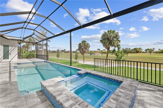 view of swimming pool featuring a patio, a yard, a lanai, and an in ground hot tub