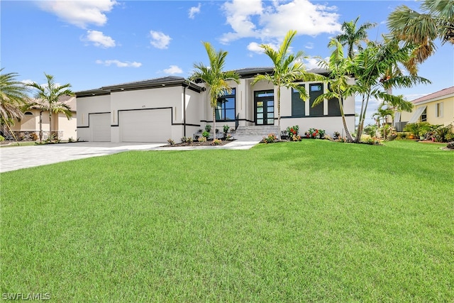 view of front of home with a garage and a front lawn