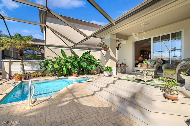 view of pool with a lanai and a patio