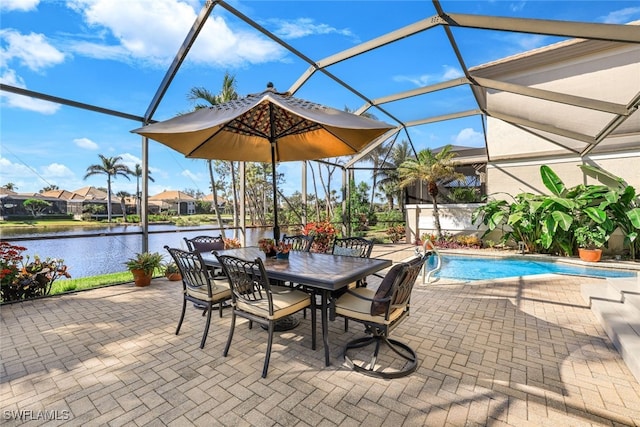 view of patio with glass enclosure and a water view