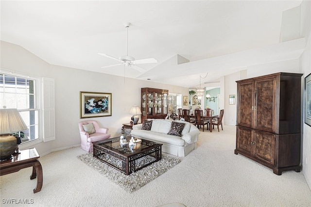 living room featuring ceiling fan, vaulted ceiling, and light carpet