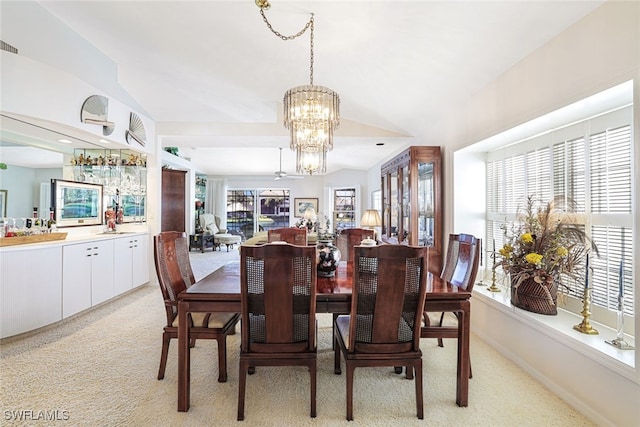 dining space with an inviting chandelier and light carpet