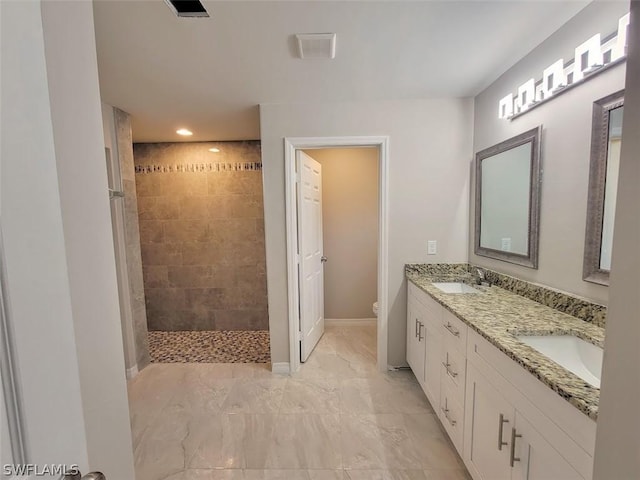 full bath with visible vents, a sink, toilet, and a walk in shower