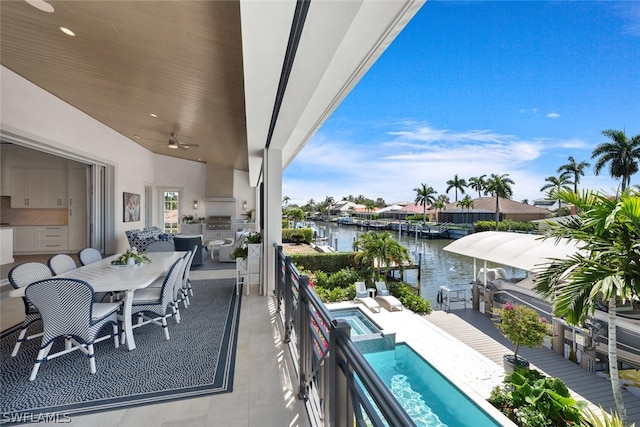 balcony with ceiling fan, a patio, a water view, a pool with connected hot tub, and outdoor dining space