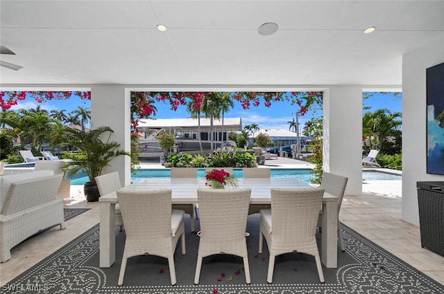 view of patio with outdoor dining area and an outdoor pool