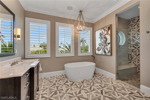 bathroom featuring plenty of natural light, vanity, and baseboards