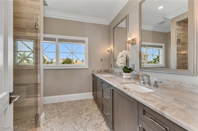 bathroom with a sink, baseboards, double vanity, a stall shower, and crown molding