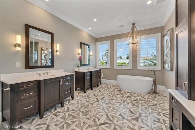 bathroom with baseboards, two vanities, a freestanding bath, and ornamental molding