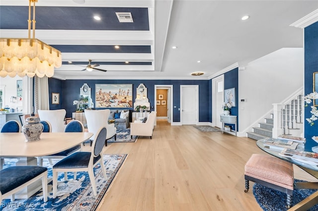 dining area featuring light wood finished floors, visible vents, stairway, and ornamental molding