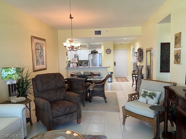 tiled living room with a chandelier