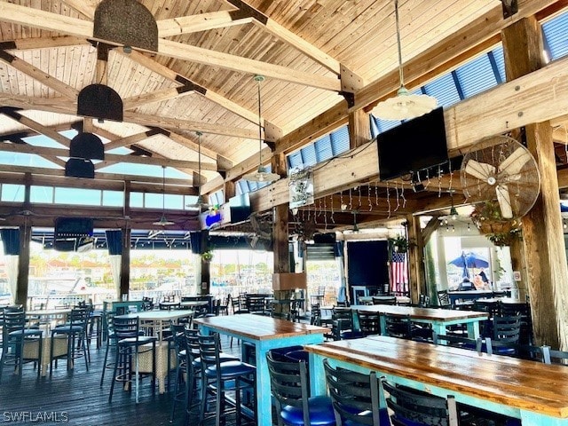 interior space with beam ceiling, butcher block counters, hardwood / wood-style floors, and wooden ceiling