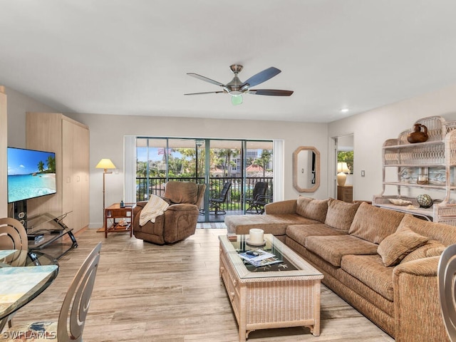 living room with ceiling fan, a healthy amount of sunlight, and light hardwood / wood-style flooring