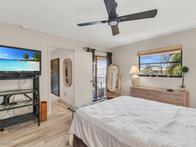 bedroom featuring multiple windows, ceiling fan, and light hardwood / wood-style flooring