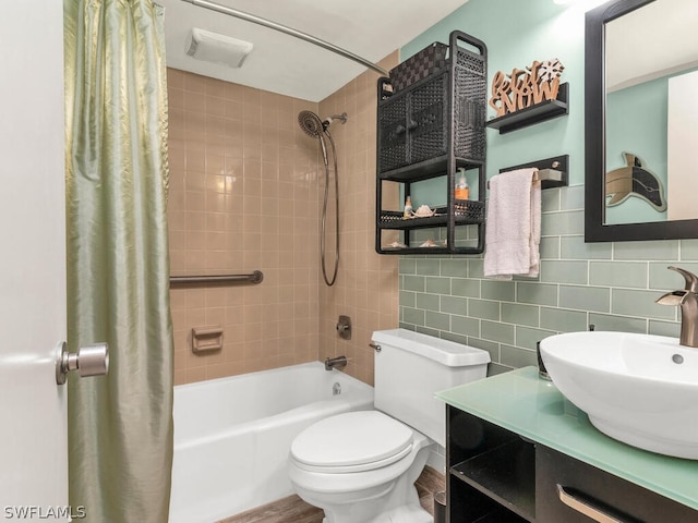 full bathroom featuring vanity, backsplash, shower / bath combo with shower curtain, tile walls, and toilet