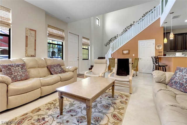 tiled living room featuring a towering ceiling