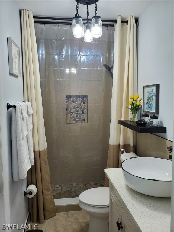 bathroom with vanity, toilet, tile patterned floors, and a shower with shower curtain