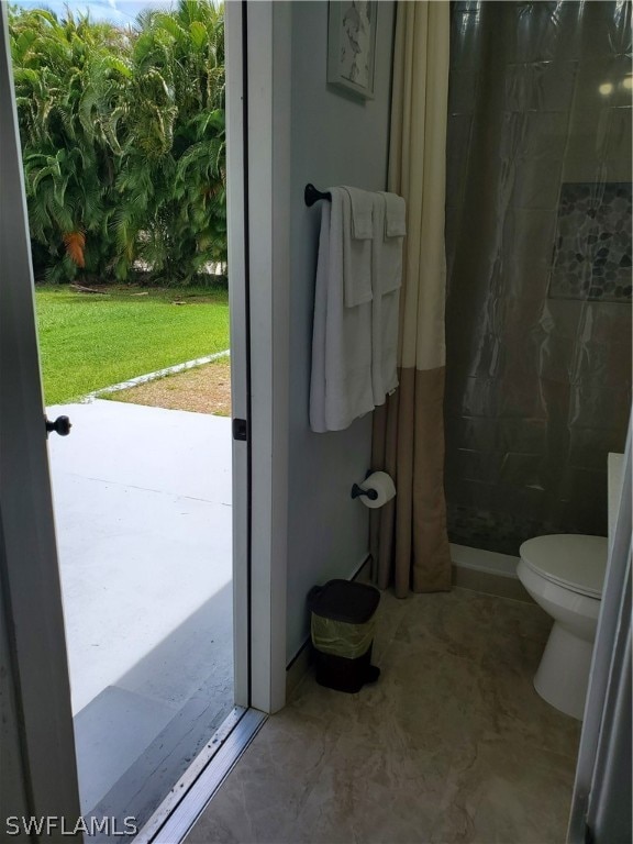 bathroom with toilet and walk in shower