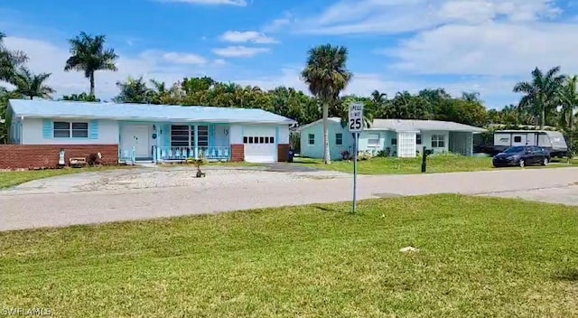 view of yard featuring a garage and covered porch