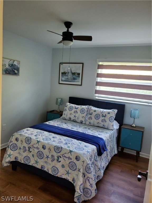 bedroom featuring wood-type flooring, multiple windows, and ceiling fan