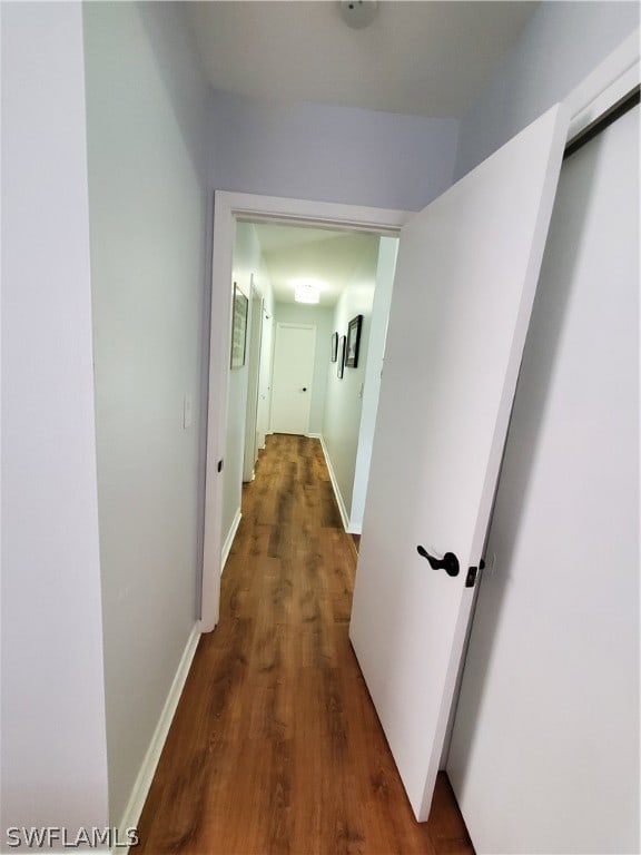 corridor with hardwood / wood-style floors