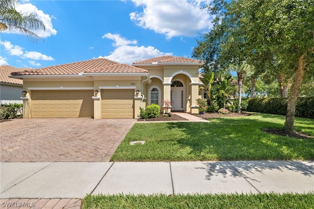 mediterranean / spanish home with a garage and a front yard