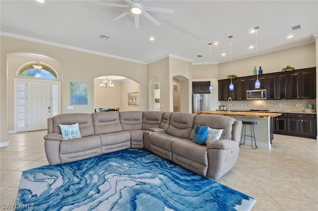 living room featuring sink, ceiling fan with notable chandelier, ornamental molding, and light tile patterned flooring