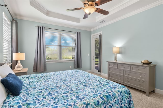 carpeted bedroom featuring a tray ceiling, access to outside, ornamental molding, and ceiling fan