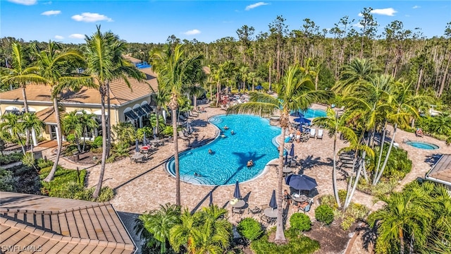 view of swimming pool with a hot tub and a patio